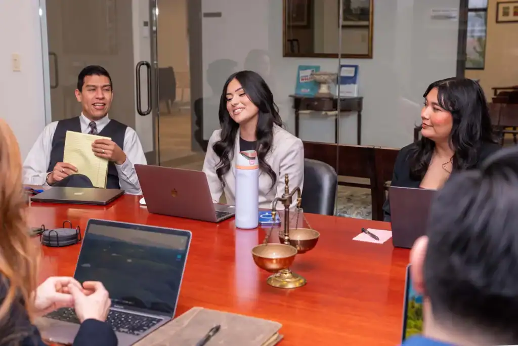 Legal team discussing case strategies in a law office conference room.