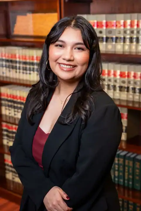 Attorney in legal library setting for professional legal services.