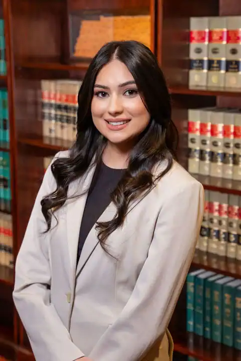 Attorney in law office with legal bookshelves background.