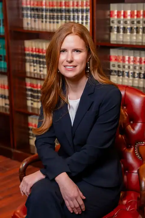Legal expert woman in law office with bookshelves background.
