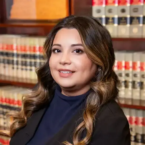 Legal professional woman in library with law books, representing legal expertise and client advocacy.